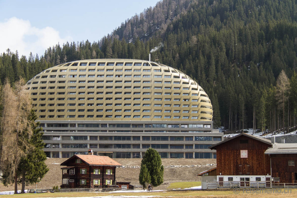 Golden facade of InterContinental hotel Davos amidst alpine landscape