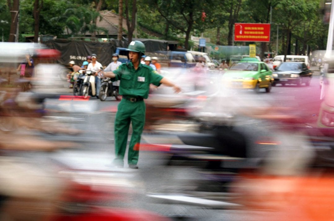 Junger Verkehrspolizist im Verkehr in Saigon