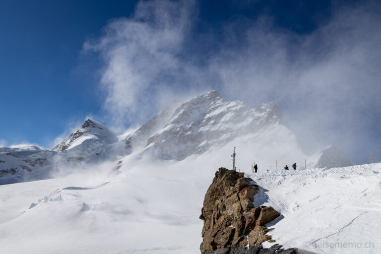 Touristen im Schneegestöber über dem Jungfraujoch Plateau